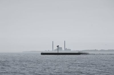 Ship sailing in sea against clear sky