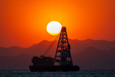 Scenic view of sea against orange sky