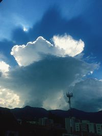 Scenic view of mountains against cloudy sky