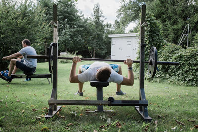 Two men working out in the garden in their home gym