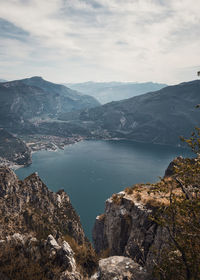 Scenic view of lake by mountains against sky
