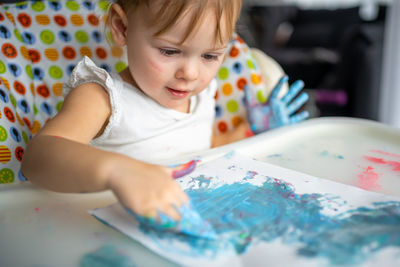 Cute girl playing with colors