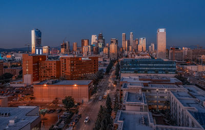 Modern cityscape against clear sky during sunset