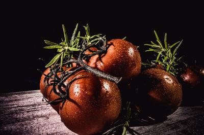 Close-up of fresh fruits on table against black background