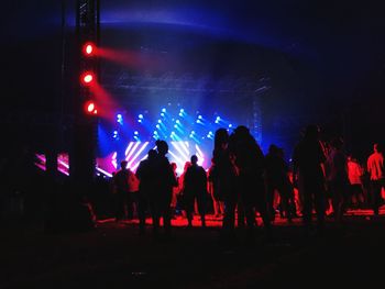 Group of silhouette people at music concert