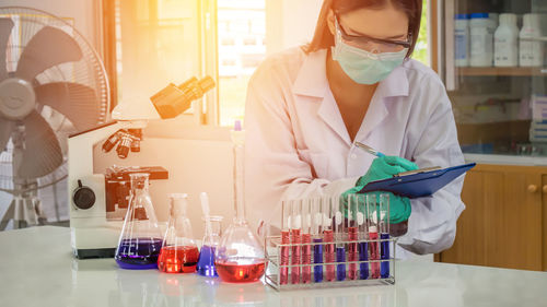 Close-up of scientist examining chemical in laboratory