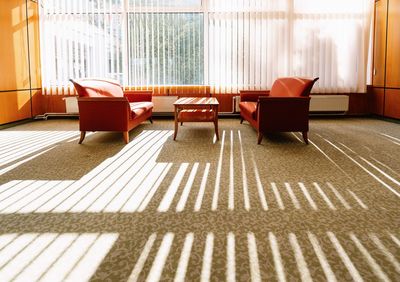 Interior of room with sofa and chairs in light and shadow