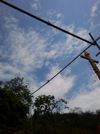 Low angle view of cables against sky