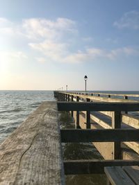 Pier over sea against sky