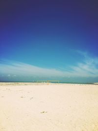 Scenic view of beach against blue sky