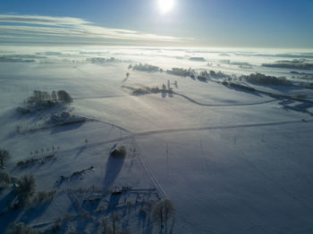 Scenic view of snow covered landscape against sky