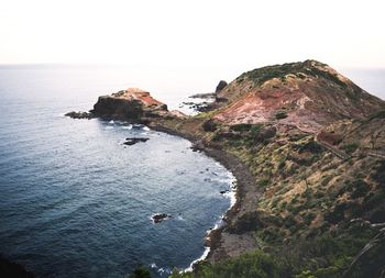High angle view of rock formation in sea against clear sky