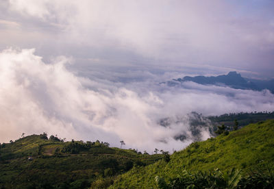 Scenic view of cloudscape over mountains against sky