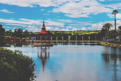 Scenic view of lake by building against sky