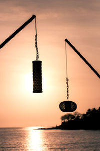 Silhouette crane against sky during sunset