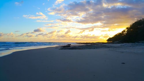 Scenic view of beach against sky during sunset