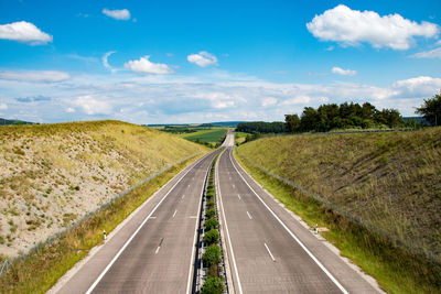 Road amidst landscape against sky