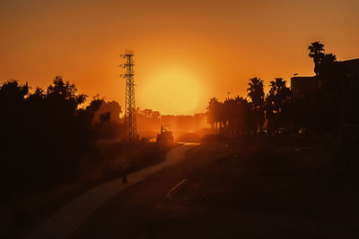 Silhouette trees against sky during sunset