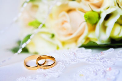 Close-up of wedding rings on table