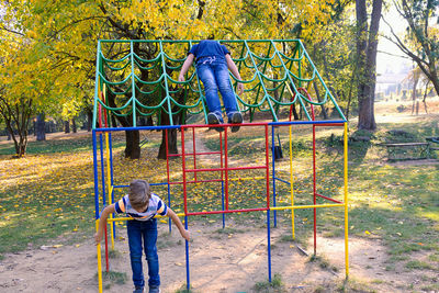 Full length of boy on slide at playground