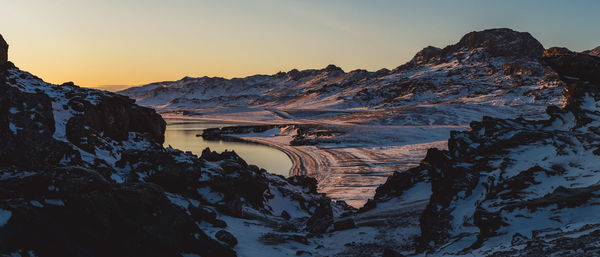 Scenic view of snowcapped mountains against sky during sunset