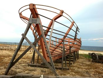 Lifeguard hut on beach against sky