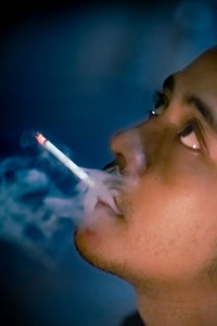 Portrait of man smoking cigarette