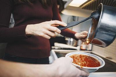 Midsection of man preparing food in kitchen