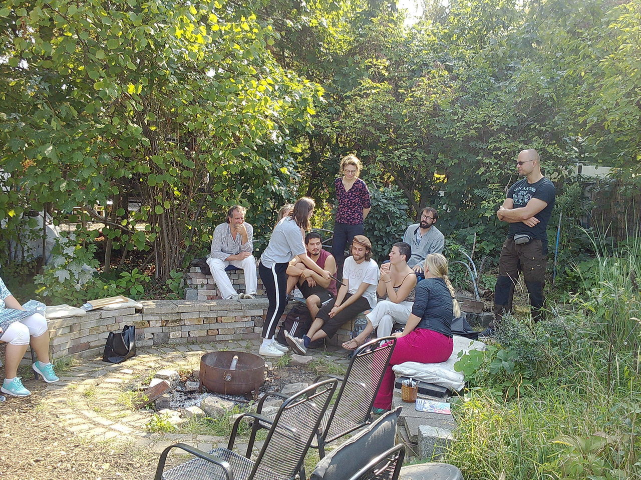 GROUP OF PEOPLE SITTING ON PLANT