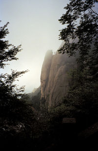 Scenic view of mountains against cloudy sky