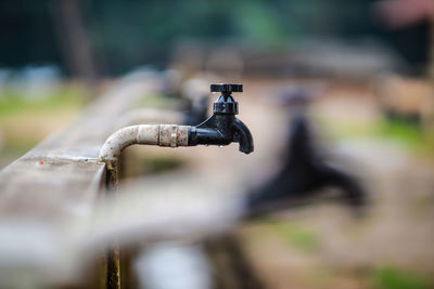 Close-up of faucet on railing