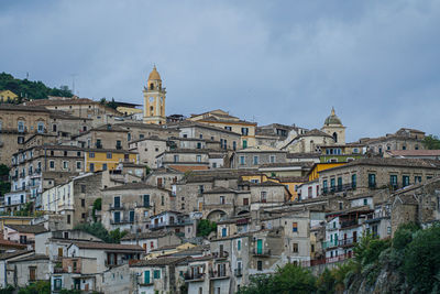 Buildings in town against sky