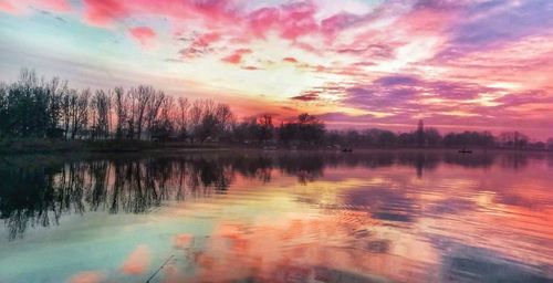 Scenic view of lake against sky at sunset