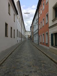 Empty alley amidst buildings in city