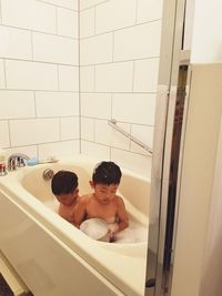 Brothers taking bath in bathtub