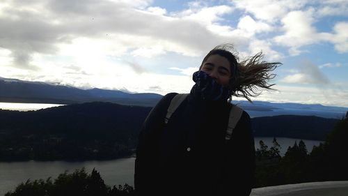 Happy woman against sky at cerro campanario during sunset