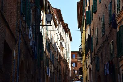 Low angle view of buildings in city against sky