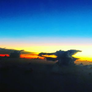 Scenic view of silhouette field against clear sky during sunset