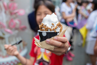 Close-up of woman holding ice cream