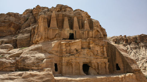 Low angle view of rock formation against clear sky