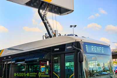 Low angle view of information sign against sky