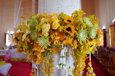 Close-up of yellow flowers hanging on plant