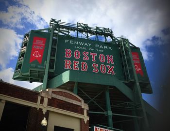 Low angle view of information sign against sky