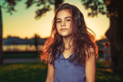 Portrait of girl against tree