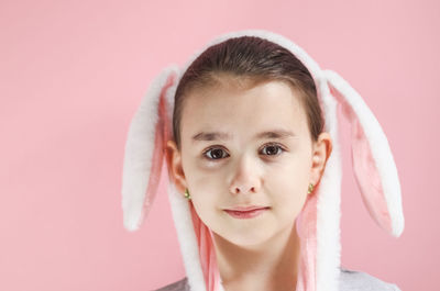 Beautiful cute caucasian smiling girl with a headband pink and white easter bunny ears