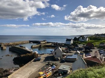 High angle view of buildings by sea against sky