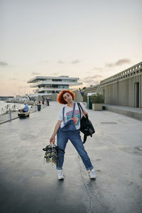 Young alternative redhead girl with roller skates at valencia's marina