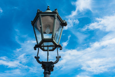 Low angle view of street light against blue sky