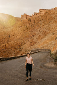 Laughing woman standing on road