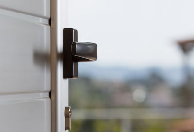 Close-up of handle on door against clear sky